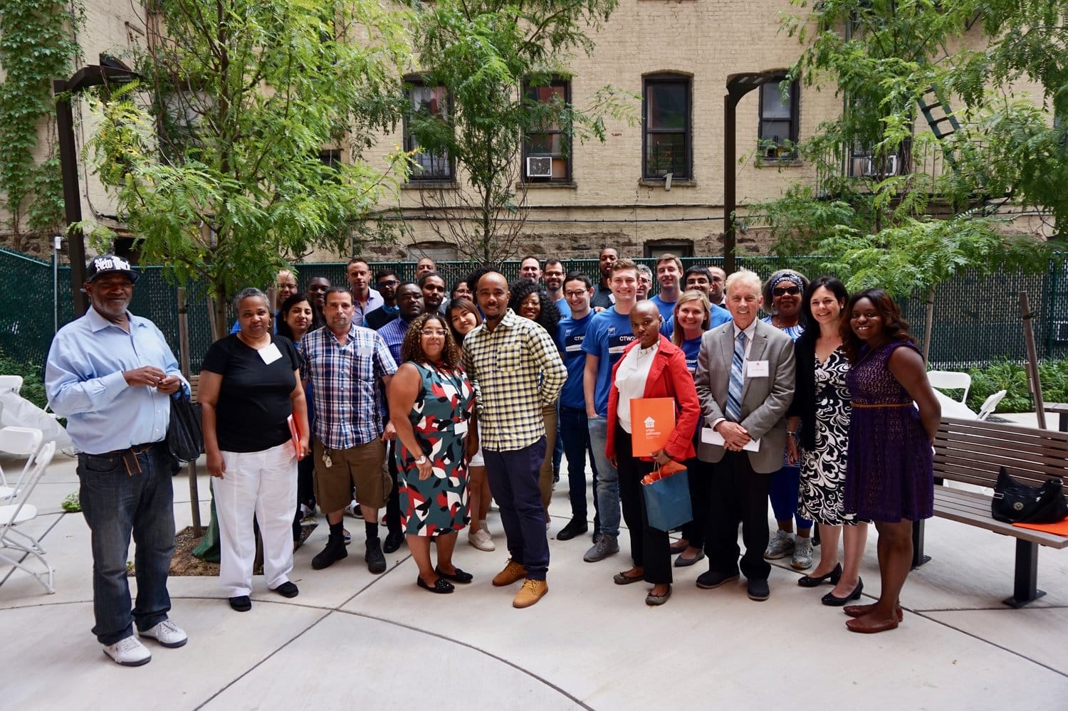 Goldman Sachs Community TeamWorks volunteers, residents, Career Enhancement program participants, Urban Pathways staff, pose during Career Day. 